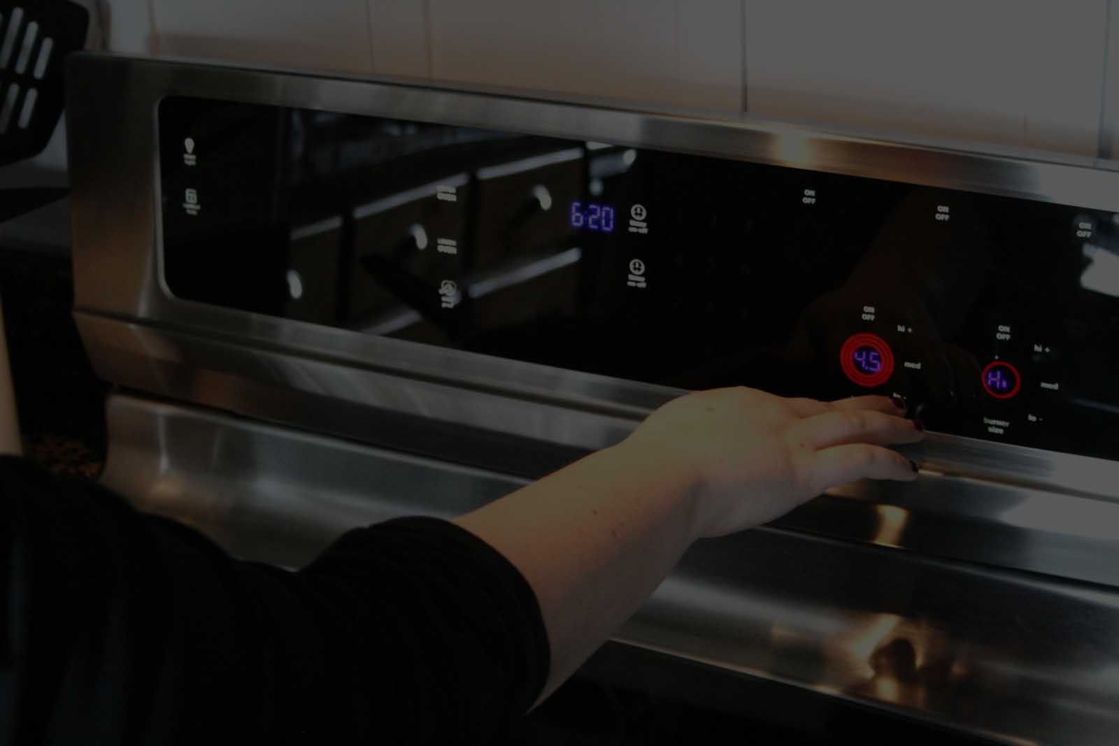 Technician servicing conveyor pizza oven